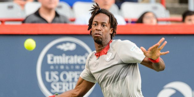 MONTREAL, ON - AUGUST 10: Gael Monfils of France looks to return the ball against Fabio Fognini of Italy during day one of the Rogers Cup at Uniprix Stadium on August 10, 2015 in Montreal, Quebec, Canada. (Photo by Minas Panagiotakis/Getty Images)