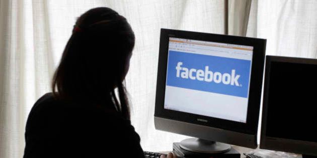 An unidentified 11-year-old girl looks at Facebook on her computer at her home in Palo Alto, Calif., on Monday, June 4, 2012. Though Facebook bans children under 13, millions of them have profiles on the site by lying about their age. The company is now testing ways to allow those kids to participate without needing to lie. This would likely be under parental supervision, such as by connecting children's accounts to their parents' accounts. (AP Photo/Paul Sakuma)