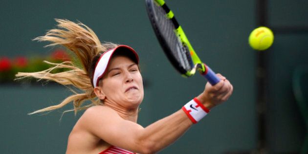 Eugenie Bouchard, of Canada, returns a shot to Timea Bacsinszky, of Switzerland, at the BNP Paribas Open tennis tournament, Monday, March 14, 2016, in Indian Wells, Calif. Bacsinszky won 6-2, 5-7, 6-2. (AP Photo/Mark J. Terrill)