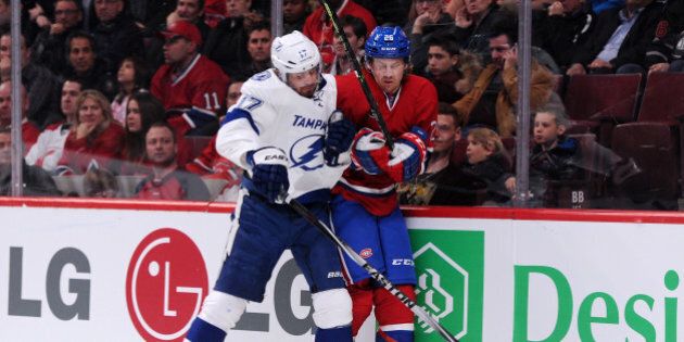 MONTREAL, QC - MARCH 10: Alex Killorn #17 of the Tampa Bay Lightning body checks Jeff Petry #26 of the Montreal Canadiens during the NHL game at the Bell Centre on March 10, 2015 in Montreal, Quebec, Canada. (Photo by Richard Wolowicz/Getty Images)