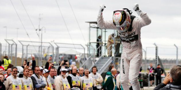 Mercedes driver Lewis Hamilton, of Britain, celebrates after winning the world championship win his victory at the Formula One U.S. Grand Prix auto race at the Circuit of the Americas, Sunday, Oct. 25, 2015, in Austin, Texas. (AP Photo/John Locher)