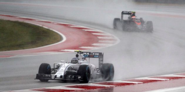 Williams driver Valtteri Bottas, of Finland, and McLaren driver Jenson Button, of Britain, right, drive during the third practice session for the Formula One U.S. Grand Prix auto race at the Circuit of the Americas, Saturday, Oct. 24, 2015, in Austin, Texas. (AP Photo/John Locher)