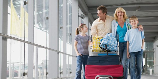 Family with suitcases in an airport