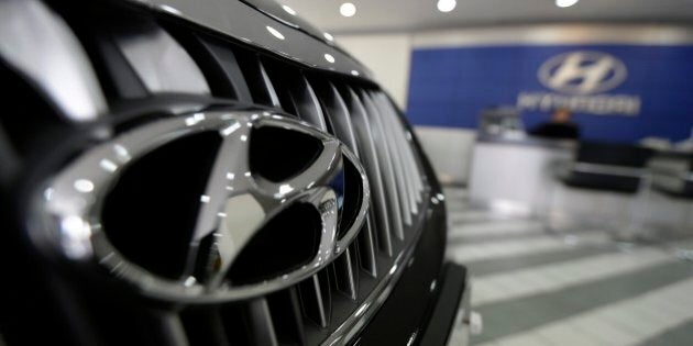 The logo of Hyundai Motor Co. is seen on a car displayed at the company's showroom in Seoul, South Korea, Thursday, April 23, 2015. The maker of Genesis sedan and Sonata said Tuesday its net income was down 2 percent over a year earlier to 1.98 trillion won ($1.83 billion) while operating income sank 18 percent to 1.59 trillion won. (AP Photo/Ahn Young-joon)