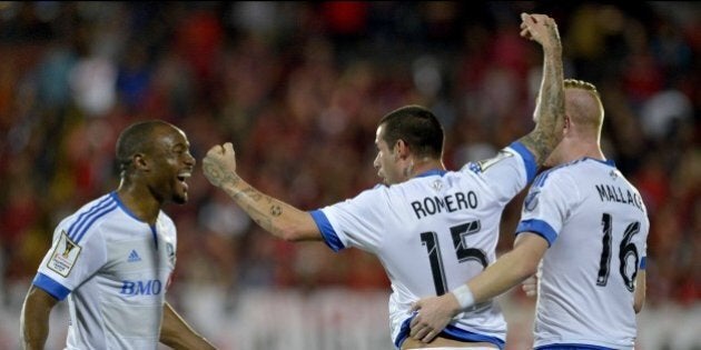 Impact of Montreal players Reo Coker (L), Andres Romero (C) and Callum Mallace (R) celebrate a goal against Liga Deportiva Alajuelense during their Concacaf Champions League semifinal match in Alejandro Morera Soto stadium in Alajuela, 25km northwest of San Jose on April 7, 2015. AFP PHOTO/Ezequiel BECERRA (Photo credit should read EZEQUIEL BECERRA/AFP/Getty Images)