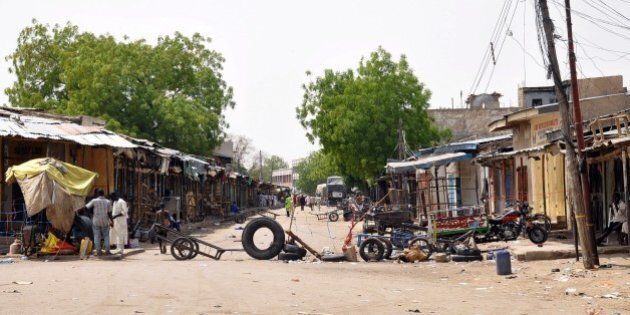 The road to the Monday Market is blocked on March 7, 2015 after a blast in Maiduguri. Three bombings in northeast Nigeria's largest city of Maiduguri killed 58 people on March 7 and wounded 139 others, the area police chief said. Reports from the three locations indicate that 58 are dead, while 139 persons were injured,' said Clement Adoda, police commissioner of Borno state, of which Maiduguri is the capital. Many children were among the dead and at least 50 others were wounded in the explosions that hit two crowded markets and a busy bus station. AFP PHOTO / PTUNJI OMIRIN (Photo credit should read TUNJI OMIRIN/AFP/Getty Images)