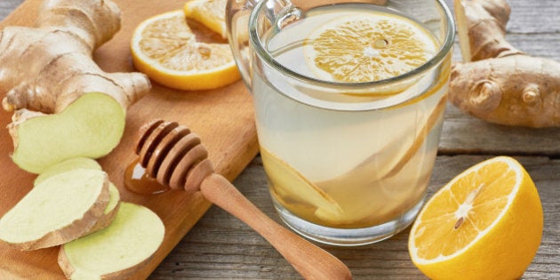 Ginger tee with lemon and honey on wooden table