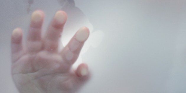 Hand of a 17 month old boy touching glass