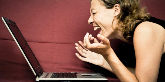 woman looking at his computer