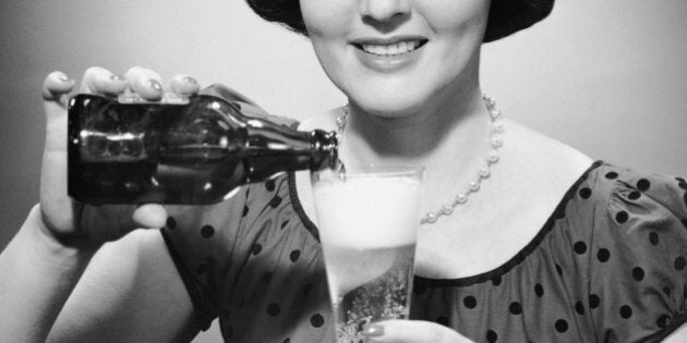 UNITED STATES - CIRCA 1950s: Woman pouring alcoholic beverage.