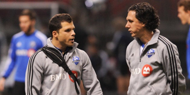 VANCOUVER, CANADA - MAY 29: Paolo Pacione (L) and assistant coach Mauro Biello (R) of the Montreal Impact confer during warm-ups prior to a match against the Vancouver Whitecaps during the finals of the Amway Canadian Championship at B.C. Place on May 29, 2013 in Vancouver, British Columbia, Canada. (Photo by Derek Leung/Getty Images)