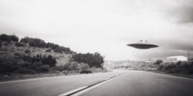 Flying saucer above highway