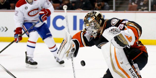 Anaheim Ducks goalie John Gibson, right, blocks a shot as Montreal Canadiens right wing Dale Weise looks on during the first period of an NHL hockey game in Anaheim, Calif., Wednesday, March 4, 2015. (AP Photo/Chris Carlson)