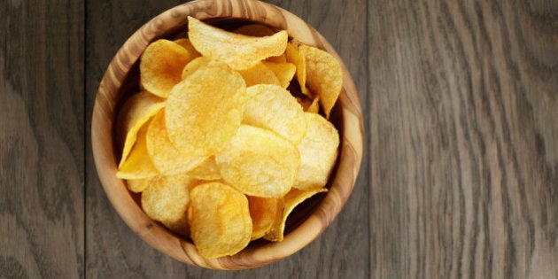 potato chips with paprika, on wood oak table