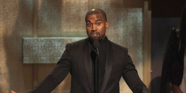 FILE - In this Jan. 24, 2015, file photo, BET Honoree Kanye West accepts the Visonary Award at the BET Honors 2015 at Warner Theater in Washington. West on Tuesday, April 7, 2015, settled a lawsuit filed by a paparazzo who the rapper attacked outside a Los Angeles International Airport terminal in 2013. Daniel Ramos' attorney Gloria Allred wrote in a statement that the suit was settled in part after West apologized to her client and the pair shook hands. (Photo by Kevin Wolf/Invision/AP, File)