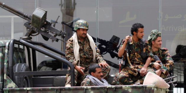 Shiite rebels, known as Houthis, wearing an army uniform, ride on an armed truck to patrol the international airport in Sanaa, Yemen, Saturday, March 28, 2015. Yemen's President Abed Raboo Mansour Hadi, speaking at an Arab summit in Egypt on Saturday, called Shiite rebels who forced him to flee the country