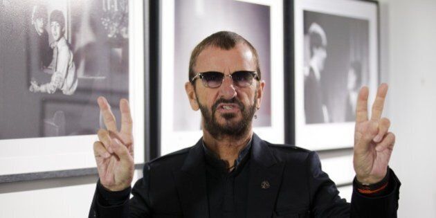 British musician Ringo Starr of legendary band The Beatles poses in front of an exhibition of photographs he took during his life during a photo call to promote his new book entitled 'photograph' at the National Portrait Gallery in London on September 9, 2015. The book gives an insight into Starr's life through rare and previously unseen photographs taken by the musician that document his childhood, The Beatles and his travels. AFP PHOTO / JUSTIN TALLIS (Photo credit should read JUSTIN TALLIS/AFP/Getty Images)