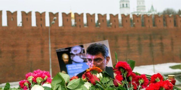 Pictures and flowers sit on February 28, 2015 at the spot, where Russian opposition leader Boris Nemtsov was shot dead, near Saint-Basil's Cathedral, in the center of Moscow. Nemtsov, a fierce critic of President Vladimir Putin, was gunned down while walking in sight of the Kremlin late on February 27, prompting an international chorus of condemnation. AFP PHOTO / ALEXANDER UTKIN (Photo credit should read ALEXANDER UTKIN/AFP/Getty Images)