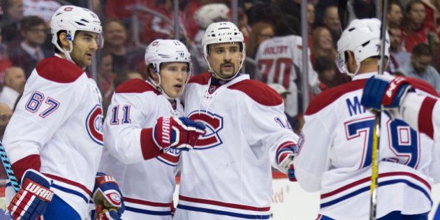 Montreal Canadiens right wing Brendan Gallagher (11) is congratulated by teammates after scoring a goal during the first period of an NHL hockey game against the Washington Capitals, on Wednesday, Feb. 24, 2016, in Washington. From left, Canadiens left wing Max Pacioretty, Gallagher, Canadiens center Tomas Plekanec, and Canadiens defenseman Andrei Markov. (AP Photo/Evan Vucci)