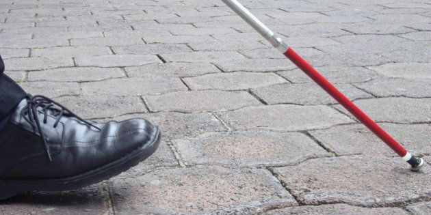 Close-Up of Blind Man's Black Shoe and White Cane Walking