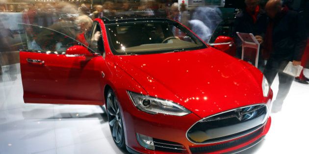 Visitors look at a Tesla Model S P85D, produced by Tesla Motors Inc., as it stands on display on day two of the 85th Geneva International Motor Show in Geneva, Switzerland, on Wednesday, March 4, 2015. The International Geneva Motor Show opens to the public on March 5, and will showcase the latest models from the world's top automakers. Photographer: Gianluca Colla/Bloomberg via Getty Images