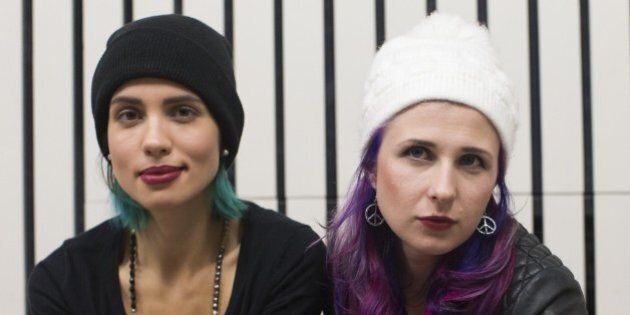Nadezhda Tolokonnikova (L) and Maria Alekhina members of the Russian punk rock band Pussy Riot pose for photographs at Amnesty International UK headquarters in East London on November 14, 2014, before speaking at a reception with activists who campaigned for their release from prison. AFP PHOTO / ANDREW COWIE (Photo credit should read ANDREW COWIE/AFP/Getty Images)