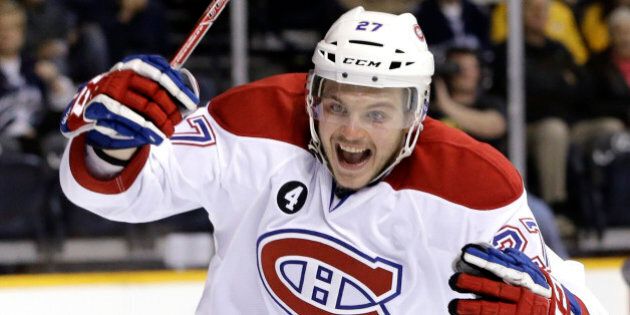 Montreal Canadiens center Alex Galchenyuk celebrates a goal scored by teammate Brendan Gallagher against the Nashville Predators in the second period of an NHL hockey game Tuesday, March 24, 2015, in Nashville, Tenn. (AP Photo/Mark Humphrey)