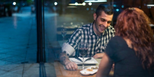 Young couple in modern restaurant having dinner