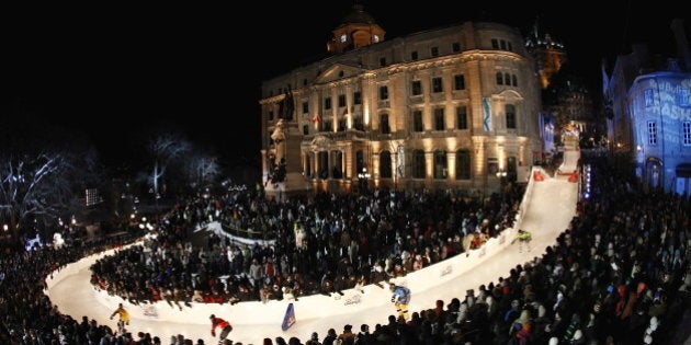 Racers make their way down the ice skating track at the Red Bull Crashed Ice competition Saturday, Jan. 24, 2009, in Quebec City. (AP Photo/Mathieu Belanger,Pool)