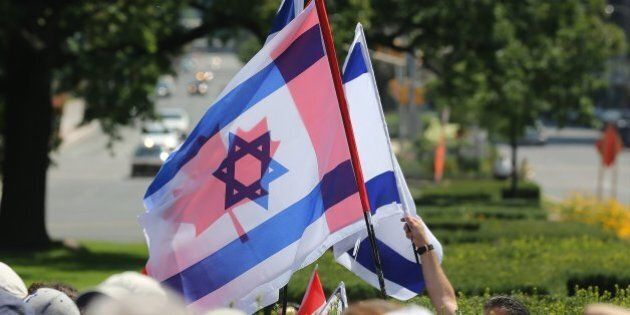 TORONTO, ON- JULY 27 - The Candian and Israeli flags fly together as Pro-Israel Torontonians gathered at Queen's Park to hold a peaceful, positive rally and pray for peace, truth and co-existence in Queen's Park in Toronto. July 27, 2014. (Steve Russell/Toronto Star via Getty Images)