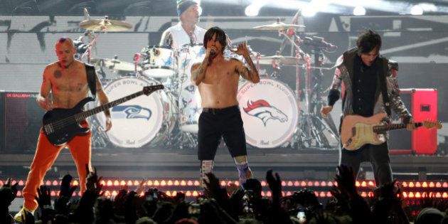 EAST RUTHERFORD, NJ - FEBRUARY 02: Flea, Chad Smith, Anthony Kiedis and Josh Klinghoffer of the Red Hot Chili Peppers perform during the Pepsi Super Bowl XLVIII Halftime Show at MetLife Stadium on February 2, 2014 in East Rutherford, New Jersey. (Photo by Larry Busacca/Getty Images)