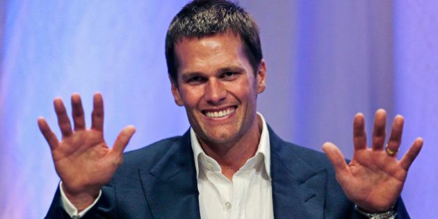 New England Patriots quarterback Tom Brady gestures during an event at Salem State University in Salem, Mass., Thursday, May 7, 2015. An NFL investigation has found that New England Patriots employees likely deflated footballs and that quarterback Tom Brady was