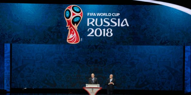 FIFA President Sepp Blatter, right, and Russian President Vladimir Putin open the preliminary draw for the 2018 soccer World Cup in Konstantin Palace in St. Petersburg, Russia, Saturday, July 25, 2015. (AP Photo/Ivan Sekretarev)