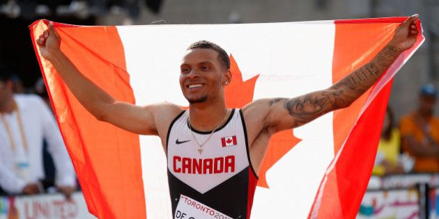 TORONTO, ON - JULY 24: Andre De Grasse of Canada holds the Canadian flag after winning the men's 200 meter final on Day 14 of the Toronto 2015 Pan Am Games on July 24, 2015 in Toronto, Canada. (Photo by Ezra Shaw/Getty Images)