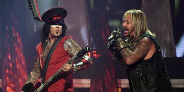 LAS VEGAS, NV - SEPTEMBER 19: Bassist Nikki Sixx (L) and singer Vince Neil of Motley Crue perform during the 2014 iHeartRadio Music Festival at the MGM Grand Garden Arena on September 19, 2014 in Las Vegas, Nevada. (Photo by Ethan Miller/Getty Images for iHeartMedia)