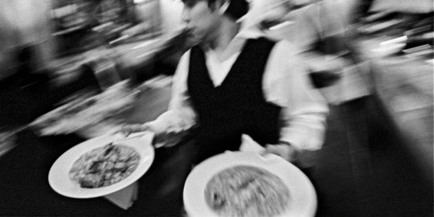 Waiter carrying plates