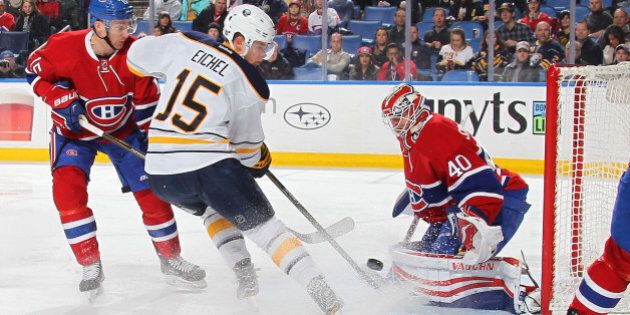BUFFALO, NY - FEBRUARY 12: Ben Scrivens #40 of the Montreal Canadiens makes a save against Jack Eichel #15 of the Buffalo Sabres alongside Tomas Fleischmann #15 of the Canadiens during an NHL game on February 12, 2016 at the First Niagara Center in Buffalo, New York. (Photo by Bill Wippert/NHLI via Getty Images)
