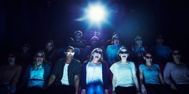 Group of people wearing 3D glasses at the movies