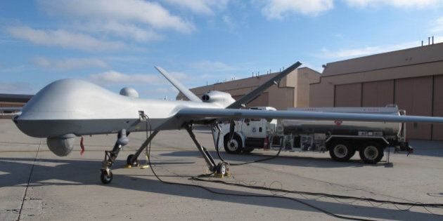 In this Nov. 3, 2015, photo, a Predator drone owned by the U.S. Customs and Border Protection sits on the tarmac awaiting takeoff from the agency's Grand Forks Air Force Base operations in North Dakota. The unmanned aircraft is about the size of a business jet and can fly for at least 20 hours, but experienced pilots say it's a difficult to plane to land. (AP Photos/Dave Kolpack)