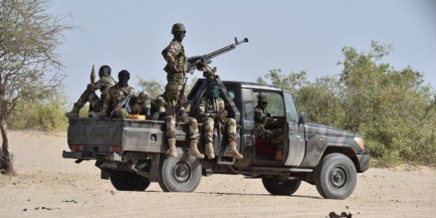 Nigerien soldiers patrol in Bosso, near the Nigerian border, on May 25, 2015. Niger has extended for three months the state of emergency in its southeastern Diffa region where the army has been battling Boko Haram militants since February, authorities announced on May 27, 2015. The operation, nicknamed Barkhane, which succedeed to Serval one, is taking place across Mauritania, Mali, Burkina Faso, Niger and Chad and involves a total 3,000 French troops. AFP PHOTO / ISSOUF SANOGO (Photo credit should read ISSOUF SANOGO/AFP/Getty Images)