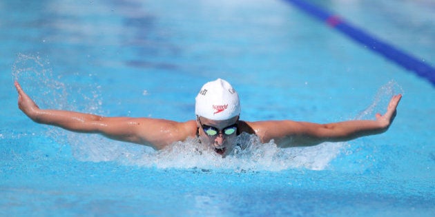 Canada's Katerine Savard swims during her women's 200-meter butterfly heat at the Pan Pacific swimming championships in Gold Coast, Australia, Thursday, Aug. 21, 2014. (AP Photo/Rick Rycroft)