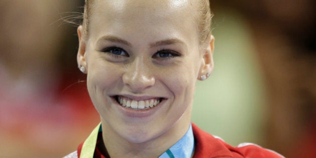 Canada's Ellie Black poses wearing her gold medal after winning it in women's artistic gymnastics balance beam competition in the Pan Am Games in Toronto, Wednesday, July 15, 2015. Black won two gold medals Wednesday, in floor exercise and balance beam. (AP Photo/Gregory Bull)