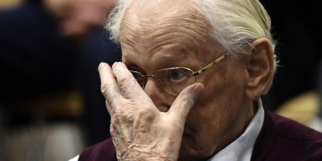 Convicted former SS officer Oskar Groening listens to the verdict of his trial on July 15, 2015 at court in Lueneburg, northern Germany. Oskar Groening, 94, sat impassively as judge Franz Kompisch said 'the defendant is found guilty of accessory to murder in 300,000 legally connected cases' of deported Jews who were sent to the gas chambers in 1944. AFP PHOTO / POOL / TOBIAS SCHWARZ (Photo credit should read TOBIAS SCHWARZ/AFP/Getty Images)