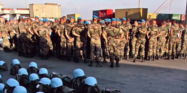 French U.N. peacekeepers' belongings and blue helmets lie at the dock as troops wait for military vehicles and equipment to get unloaded from the French chartered cargo ship Fast Arrow that docked at the port of Beirut, Lebanon, Tuesday, Sept. 12, 2006, carrying heavy equipment for French peacekeepers in the U.N. force monitoring the cease-fire between Israel and Hezbollah. France, which currently leads the U.N. peacekeeping mission in Lebanon known as UNIFIL, is expected to increase its contribution to 2,000 soldiers as part of a force of 15,000 that will help the Lebanese army establish authority along the Lebanese-Israeli border. (AP Photo/Alvaro Barrientos)