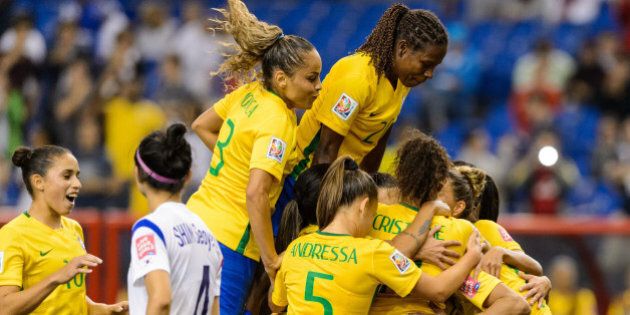 MONTREAL, QC - JUNE 09: Marta #10 of Brazil celebrates a goal on a penalty kick with teammates in the second half during the 2015 FIFA Women's World Cup Group E match against Korea Republic at Olympic Stadium on June 9, 2015 in Montreal, Quebec, Canada. (Photo by Minas Panagiotakis/Getty Images)