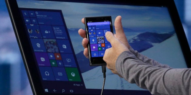 Joe Belfiore, Microsoft Corporate Vice President of Operating Systems Group, demonstrates Continuum for phones at the Microsoft Build conference in San Francisco, Wednesday, April 29, 2015. While Microsoft has already previewed some aspects of the new Windows 10, a parade of top executives will use the conference to demonstrate more software features and app-building tools, with an emphasis on mobile devices as well as PCs. (AP Photo/Jeff Chiu)