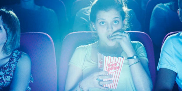 Woman enjoying movie at cinema