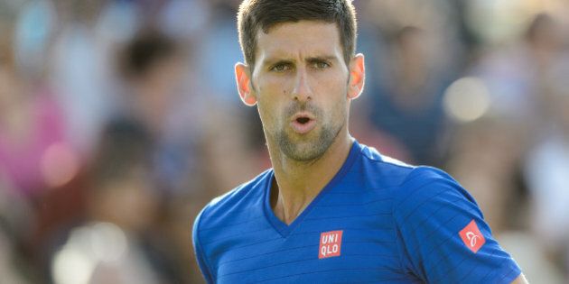 MONTREAL, ON - AUGUST 12: Novak Djokovic of Serbia looks on in his doubles match against Rohand Bopanna of India and Florin Mergea of Romania during day three of the Rogers Cup at Uniprix Stadium on August 12, 2015 in Montreal, Quebec, Canada. (Photo by Minas Panagiotakis/Getty Images)