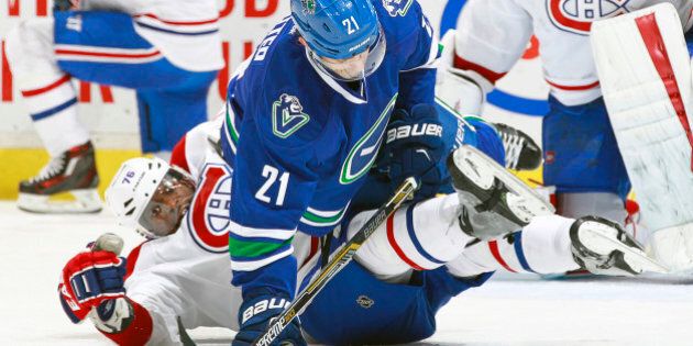 VANCOUVER, BC - OCTOBER 27: Brandon Sutter #21 of the Vancouver Canucks falls on P.K. Subban #76 of the Montreal Canadiens during their NHL game at Rogers Arena October 27, 2015 in Vancouver, British Columbia, Canada. (Photo by Jeff Vinnick/NHLI via Getty Images)