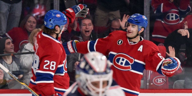 MONTREAL, QC - FEBRUARY 21: Max Pacioretty #67 of the Montreal Canadiens celebrate with teammate Nathan Beaulieu #28 after scoring a second goal against the Columbus Blue Jackets in the NHL game at the Bell Centre on February 21, 2015 in Montreal, Quebec, Canada. (Photo by Francois Lacasse/NHLI via Getty Images)